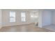 Bright living room with hardwood floors and two large picture windows at 9345 Anthem Ave, Plainfield, IN 46168