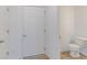 Compact powder room with modern white door and a glimpse of the toilet and sink at 9345 Anthem Ave, Plainfield, IN 46168