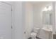 Cozy powder room with pedestal sink, updated fixtures, and a modern white door at 9345 Anthem Ave, Plainfield, IN 46168