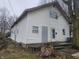 Two-story home featuring white siding, multi-pane windows, and a modest front porch at 1031 Nichol Ave, Anderson, IN 46016