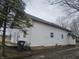 Side view of a two-story home with white siding and visible roofline at 1031 Nichol Ave, Anderson, IN 46016