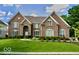 Beautiful brick home with manicured lawn, arched entryway, and symmetrically placed windows at 11478 Muirfield Trce, Fishers, IN 46037