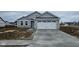New construction featuring stone accents, gray siding, and an attached two-car garage at 13862 N Americus Way, Camby, IN 46113
