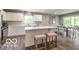 Bright kitchen with white cabinetry, a center island, and a view of the backyard at 13862 N Americus Way, Camby, IN 46113