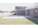 Spacious backyard with a concrete patio and a view of a serene pond in the distance at 1393 N Salem Ct, Greenfield, IN 46140