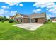 Spacious backyard featuring a well-maintained lawn and concrete patio, perfect for outdoor entertaining at 1393 N Salem Ct, Greenfield, IN 46140
