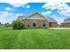 Lush green backyard showing the home's exterior, with ample space for outdoor enjoyment at 1393 N Salem Ct, Greenfield, IN 46140