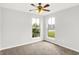 Bright bedroom featuring two windows, neutral carpeting, and fresh, white paint at 1393 N Salem Ct, Greenfield, IN 46140