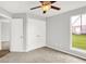Neutral bedroom featuring a ceiling fan, large closet, and window with a view at 1393 N Salem Ct, Greenfield, IN 46140