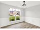 Bright dining room with wainscoting, wood floors, and a view of the front yard at 1393 N Salem Ct, Greenfield, IN 46140