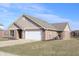 Well-maintained single story home with a brick facade, two car garage, and neat landscaping at 1393 N Salem Ct, Greenfield, IN 46140