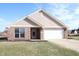 Charming single-story brick home featuring an attached two-car garage and manicured front lawn at 1393 N Salem Ct, Greenfield, IN 46140