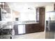Well-equipped kitchen with dark cabinets, stainless steel appliances, and granite countertops at 1393 N Salem Ct, Greenfield, IN 46140