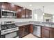 Stylish kitchen showcases stainless steel appliances, granite counters, and dark wood cabinets at 1393 N Salem Ct, Greenfield, IN 46140