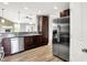 Well-lit kitchen features stainless steel appliances, granite countertops, and dark wood cabinetry at 1393 N Salem Ct, Greenfield, IN 46140