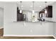 Kitchen with stainless steel appliances, granite countertops, and bar overlooking living area at 1393 N Salem Ct, Greenfield, IN 46140