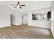 Open concept living room view to kitchen with vaulted ceilings and vinyl plank flooring at 1393 N Salem Ct, Greenfield, IN 46140