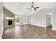 Spacious living room with stone fireplace, high ceilings, fan, and a clear backyard view at 1393 N Salem Ct, Greenfield, IN 46140