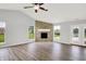 Bright and spacious living room with a stone fireplace, wood floors and large windows at 1393 N Salem Ct, Greenfield, IN 46140