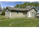 The exterior of the home shows vinyl siding and a well-maintained lawn at 1435 E New Rd, Greenfield, IN 46140