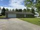 Ranch style home with attached garage, concrete drive, and well-kept lawn at 1435 E New Rd, Greenfield, IN 46140