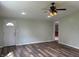 Cozy living room with hardwood floors, a ceiling fan, and an open doorway to another room at 1435 E New Rd, Greenfield, IN 46140