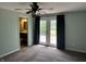 Main bedroom with carpet, access to bathroom and deck with French doors at 1435 E New Rd, Greenfield, IN 46140