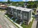 Aerial view of modern townhomes with sleek design, black trim, well-maintained landscaping, and concrete walkways at 1517 E New York St, Indianapolis, IN 46201