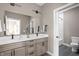 Bathroom with double vanity, large mirror, tile flooring, and a shower/tub combination at 1517 E New York St, Indianapolis, IN 46201