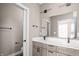Bathroom featuring double sinks with light wood cabinets, white countertops, and black hardware at 1517 E New York St, Indianapolis, IN 46201
