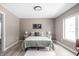 Modern bedroom with a neutral color scheme, featuring a large window and light wood floors at 1517 E New York St, Indianapolis, IN 46201