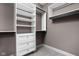 Walk-in closet with custom shelving and drawers for optimal organization at 1517 E New York St, Indianapolis, IN 46201