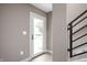 Bright entryway featuring a white door with glass and a modern staircase with black railings at 1517 E New York St, Indianapolis, IN 46201