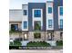 New townhouse exterior featuring modern design with brick and metal accents plus a small front lawn at 1517 E New York St, Indianapolis, IN 46201