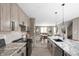 Open kitchen with granite countertops, modern appliances, island, and hardwood floors at 1517 E New York St, Indianapolis, IN 46201
