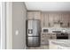 Well-equipped kitchen showcases stainless steel refrigerator and stylish cabinets with modern hardware at 1517 E New York St, Indianapolis, IN 46201