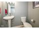 Cozy half bath featuring a pedestal sink and modern toilet at 1623 N College Ave # 2, Indianapolis, IN 46202