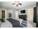 Cozy bedroom featuring neutral walls, ceiling fan, dresser, and walk-in closet at 1623 N College Ave # 2, Indianapolis, IN 46202
