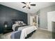 Bedroom featuring natural light, ceiling fan, and dark accent wall at 1623 N College Ave # 2, Indianapolis, IN 46202
