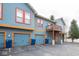 Apartment complex featuring colorful exterior, garages, and ample parking at 1623 N College Ave # 2, Indianapolis, IN 46202