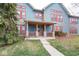 Charming front porch with stone pillars, wood railing, and front door at 1623 N College Ave # 2, Indianapolis, IN 46202