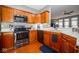 Kitchen with stainless appliances, granite countertop, and wood cabinetry at 1623 N College Ave # 2, Indianapolis, IN 46202