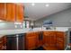 Well-lit kitchen with stainless steel appliances, granite countertop, and wood cabinetry at 1623 N College Ave # 2, Indianapolis, IN 46202