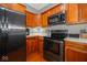 Kitchen with stainless steel appliances and wood cabinetry at 1623 N College Ave # 2, Indianapolis, IN 46202
