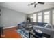 Spacious living room with hardwood floors, a ceiling fan, and plenty of natural light at 1623 N College Ave # 2, Indianapolis, IN 46202