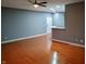 Open living space with wood floors, a view of the kitchen, and neutral walls at 1623 N College Ave # 2, Indianapolis, IN 46202