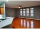 Spacious living room featuring a ceiling fan, natural light, and wood flooring at 1623 N College Ave # 2, Indianapolis, IN 46202