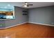Living room with hardwood floors and a view of the kitchen area at 1623 N College Ave # 2, Indianapolis, IN 46202