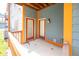 Private patio with wood railing, featuring access to interior with twin entry doors at 1623 N College Ave # 2, Indianapolis, IN 46202