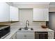 Close-up of the kitchen sink area, highlighting the white cabinets, marble countertops, and modern faucet fixtures at 2534 Morning Star Dr, Indianapolis, IN 46229